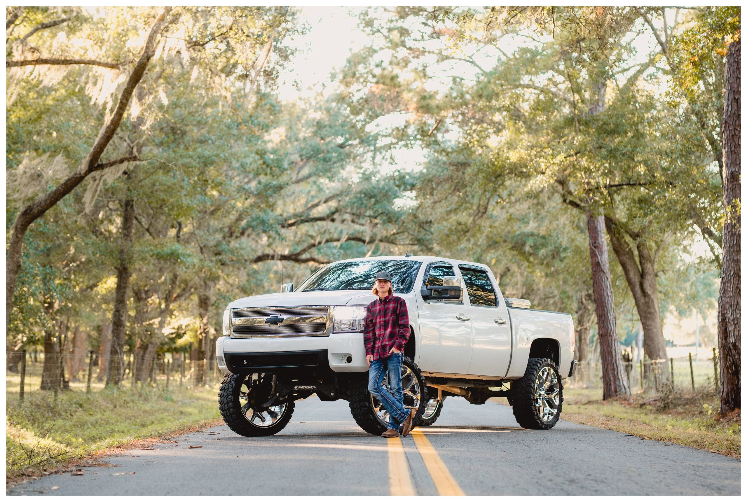 Senior boy takes photos with his truck for portraits in North Florida.