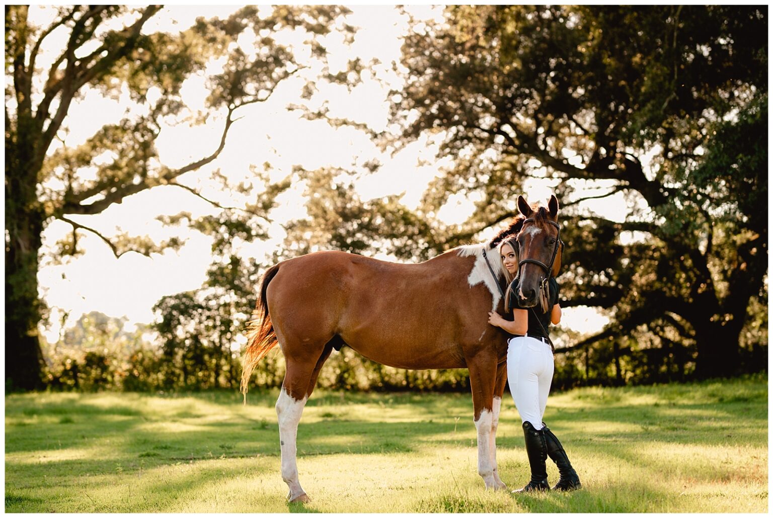Tallahassee equestrian photographed with her pinto Thoroughbred gelding at Gray Lily Farms. Free Ride Equestrian outfit. Florida horse and rider photographer.