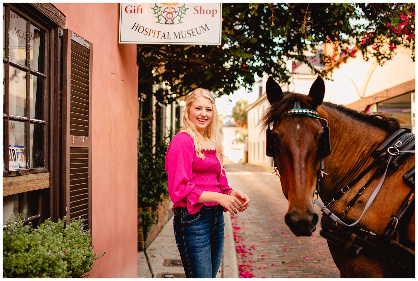 Downtown St Augustine street for senior portraits. Senior photo outfit ideas, hot pink shirt with cheetah heels.