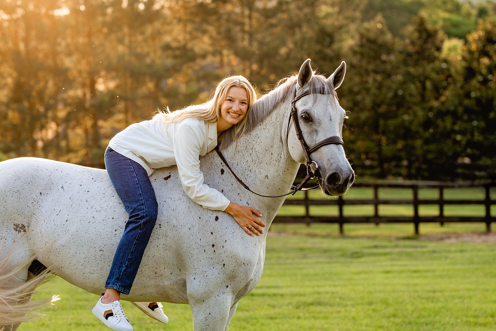 Professional horse photographer near Birmingham, Alabama takes photos of girl on her Dutch Warmblood jumper gelding at sunset.