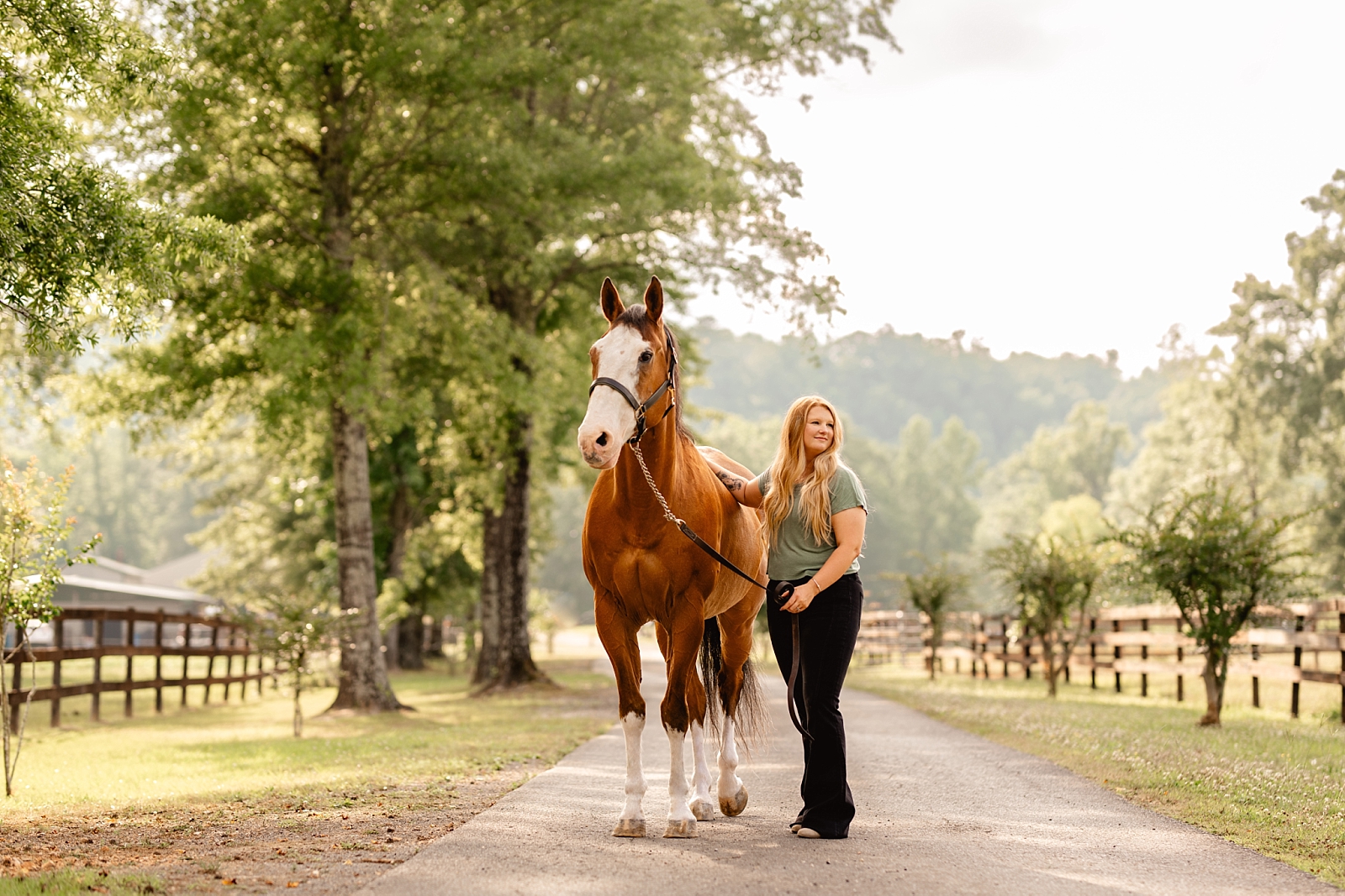 Equestrian photographer in Alabama. Woman with her first horse with the Alabama mountains in the background.