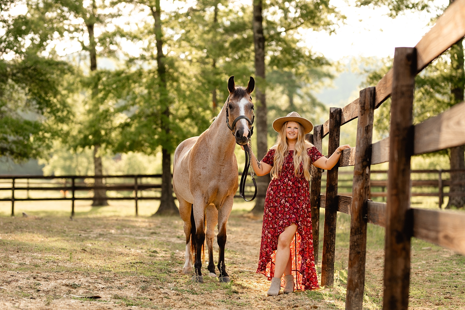 Girl in pretty floral dress and hat takes photos with bay roan AQHA mare in Northern Alabama at Riverbend Farm. Equestrian Photographer in Alabama, Painted Oak Photography.