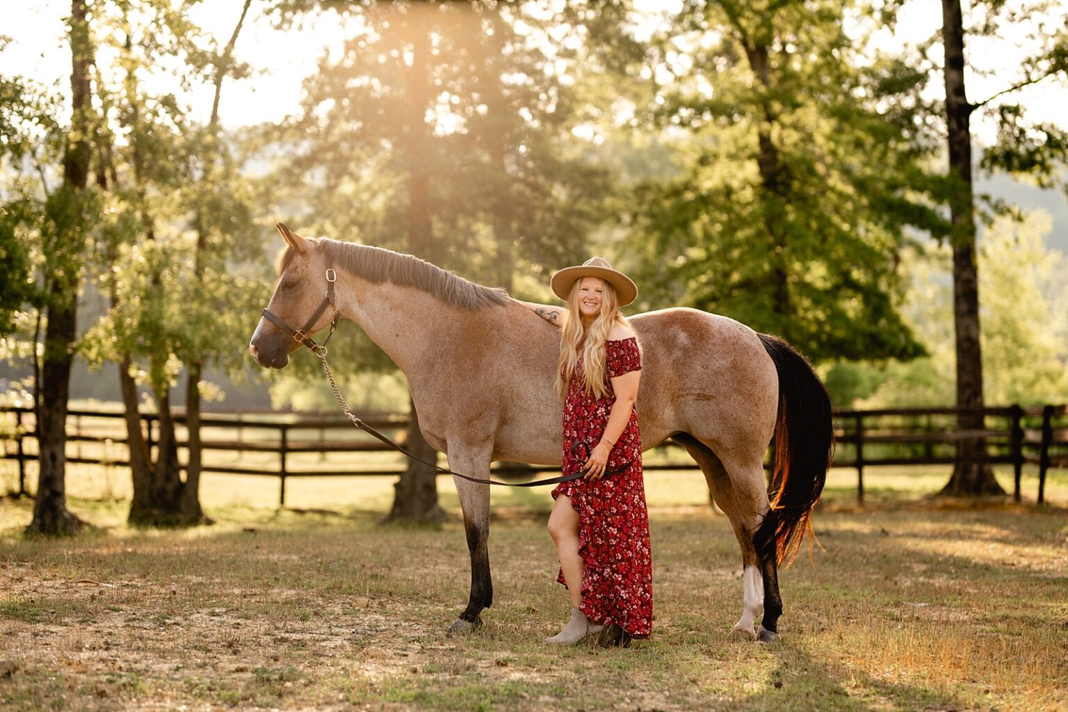 Girl in pretty floral dress and hat takes photos with bay roan AQHA mare in Northern Alabama at Riverbend Farm. Equestrian Photographer in Alabama, Painted Oak Photography.