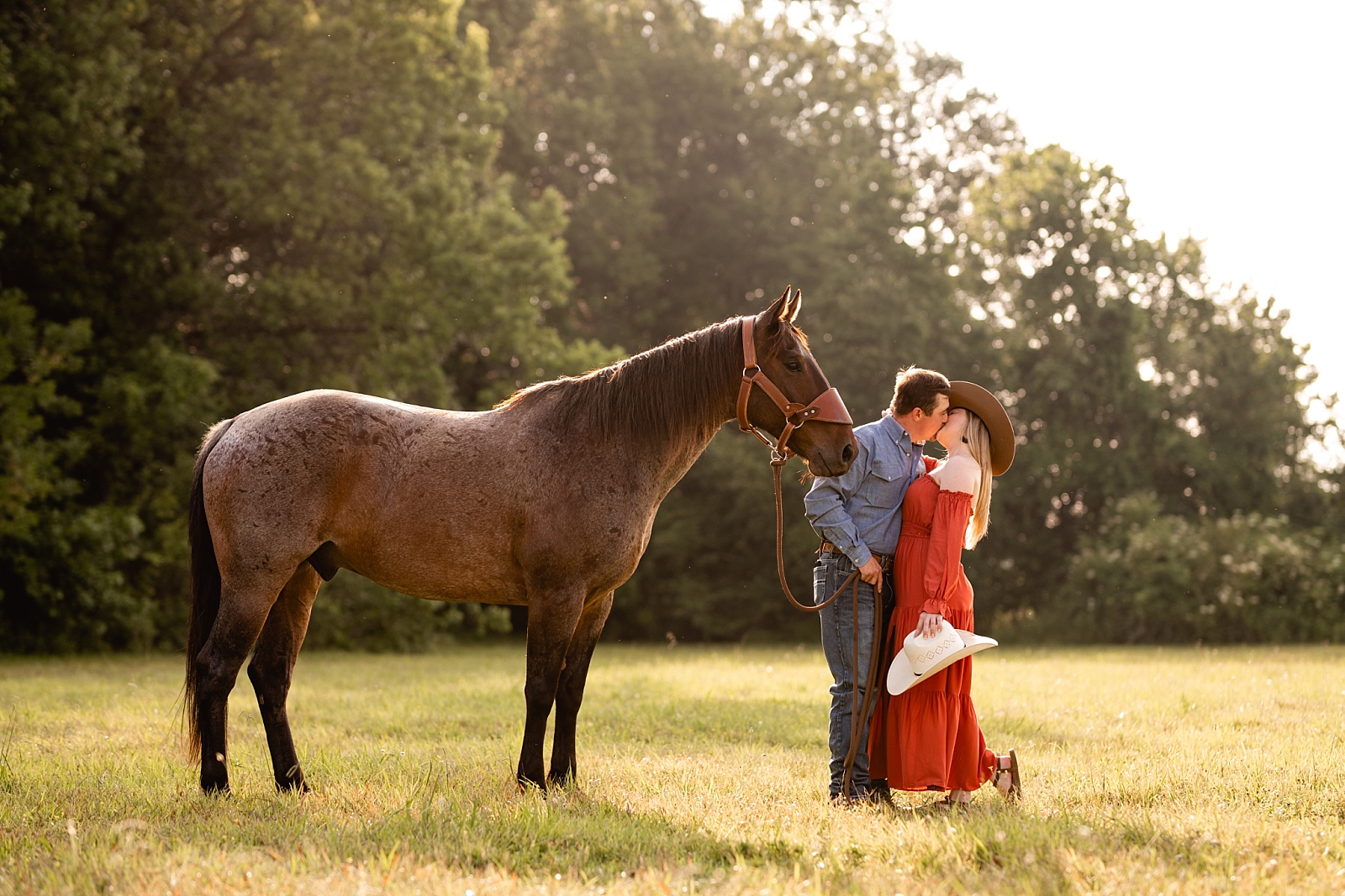 Posing ideas for couples with horses. Western couple photographed near Huntsville, AL.