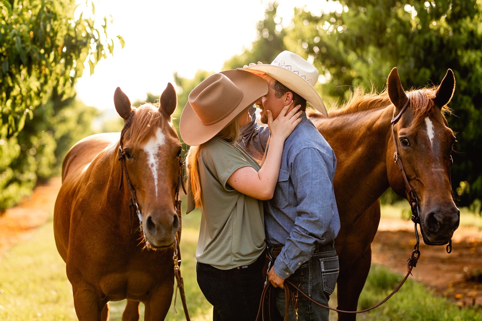 Posing ideas for couples with two horses. Western couple takes photos together with two horses in Northern Alabama.