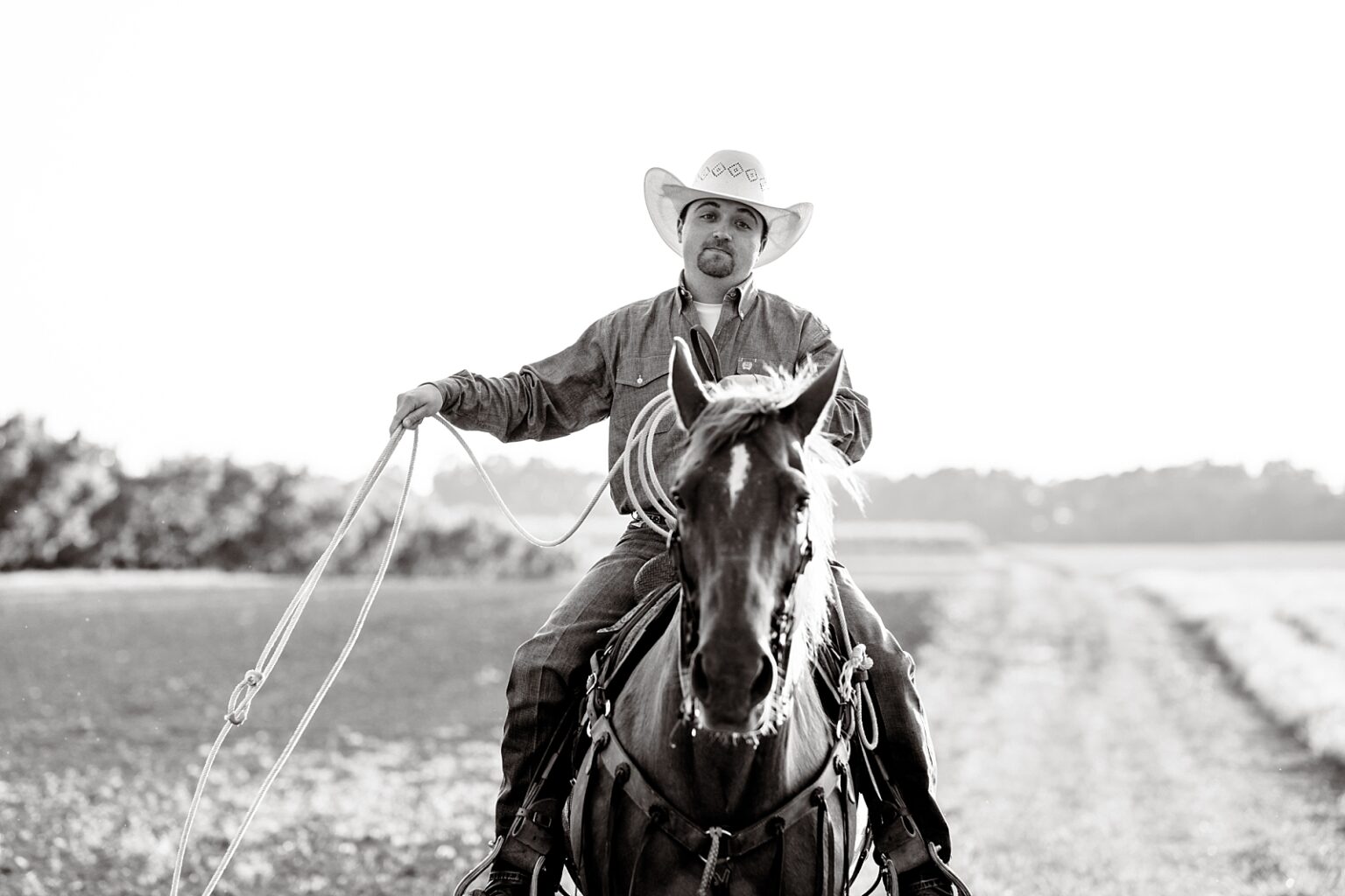 Cowboy with his roping horse at sunset in Northern Alabama.a