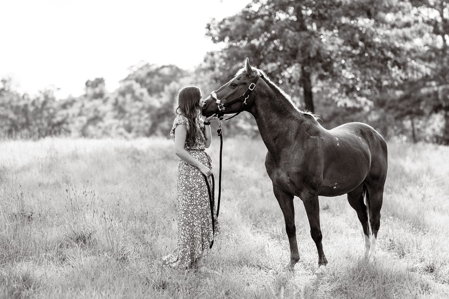 Western horse photographer in Alabama takes photos of barrel racer with her heart horse in floral blue dress.