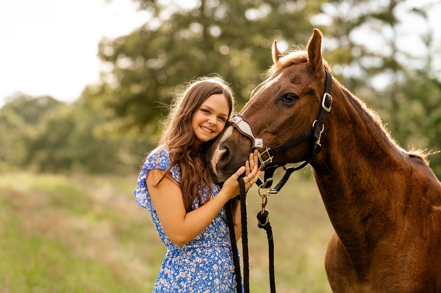 Western horse photographer in Alabama takes photos of barrel racer with her heart horse in floral blue dress.