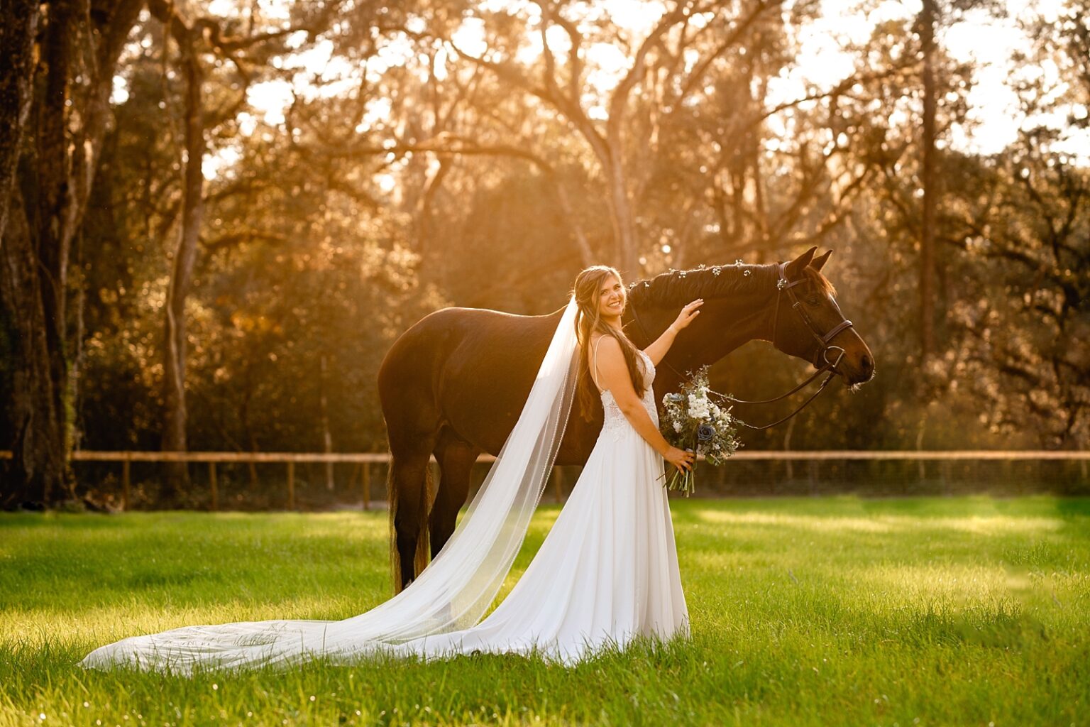 Equestrian bride takes pictures with her horse at her wedding. She put baby's breath in the horses mane. Posing ideas for bride and horse.