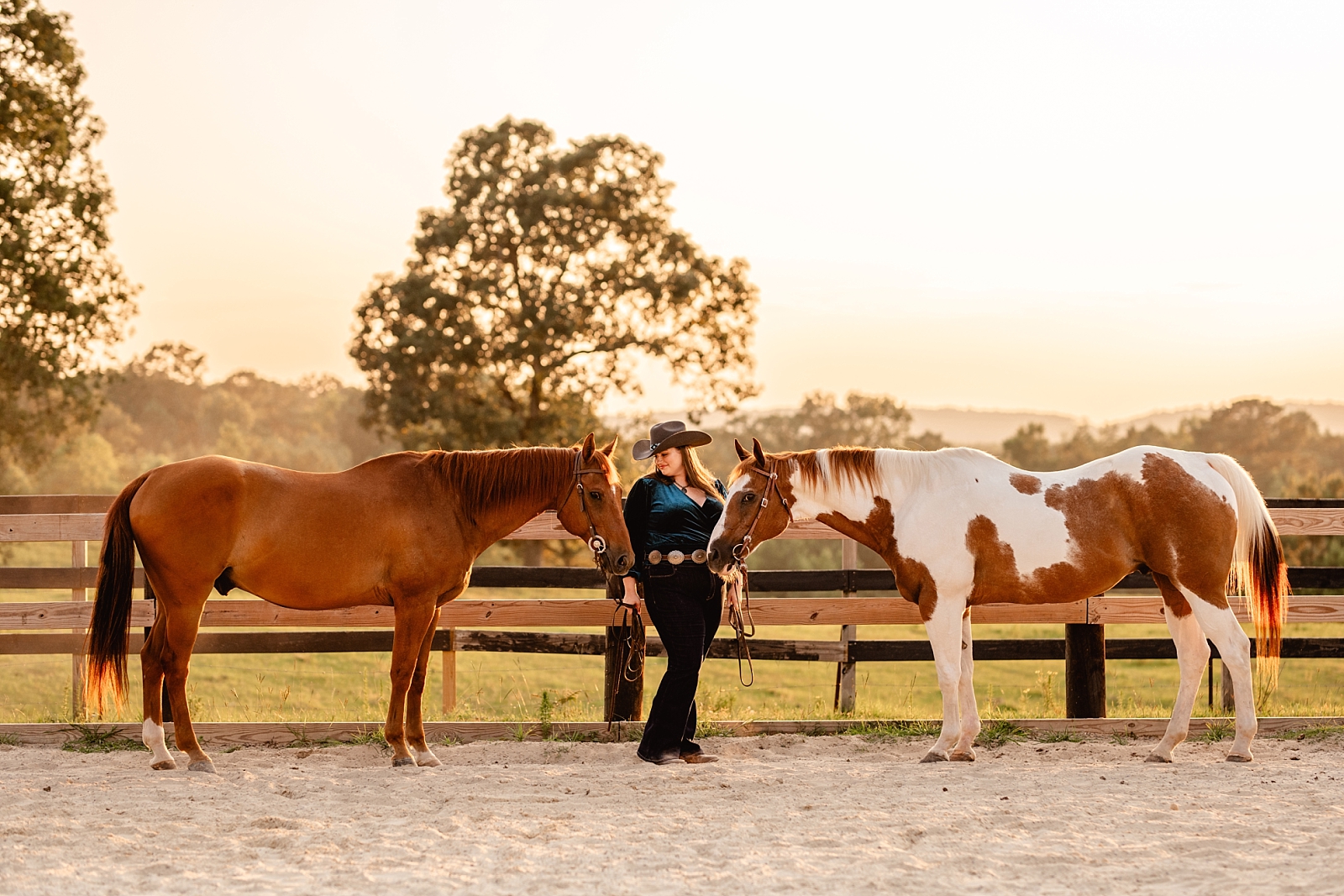 Western Equine Photographer in Alabama takes photos of woman with her two horses at sunset.