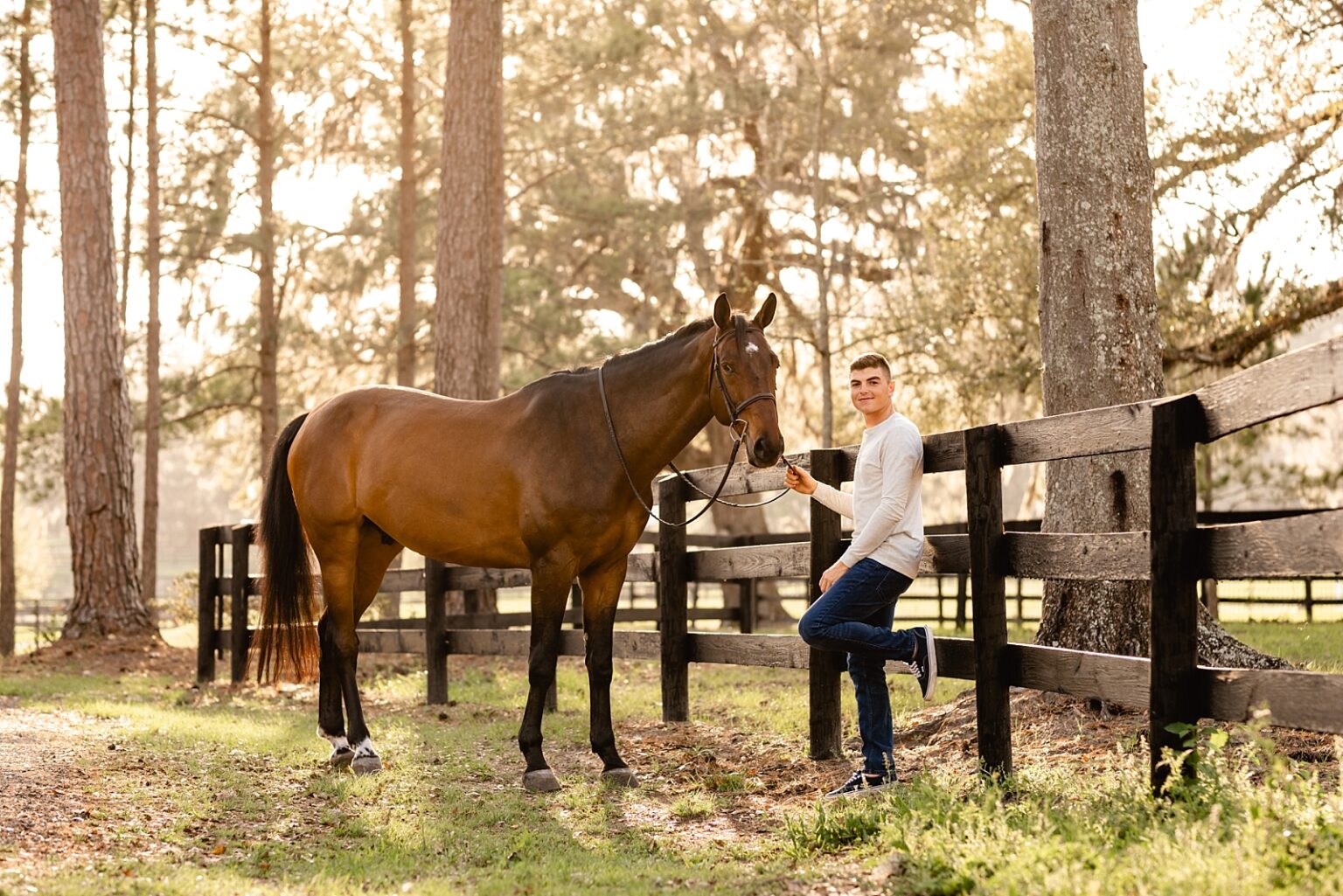 Young rider featured in Sidelines Magazine, Jordan Melfi, takes photos with his jumper gelding in Ocala, FL. Male horse and rider session. Horse and rider posing for men.