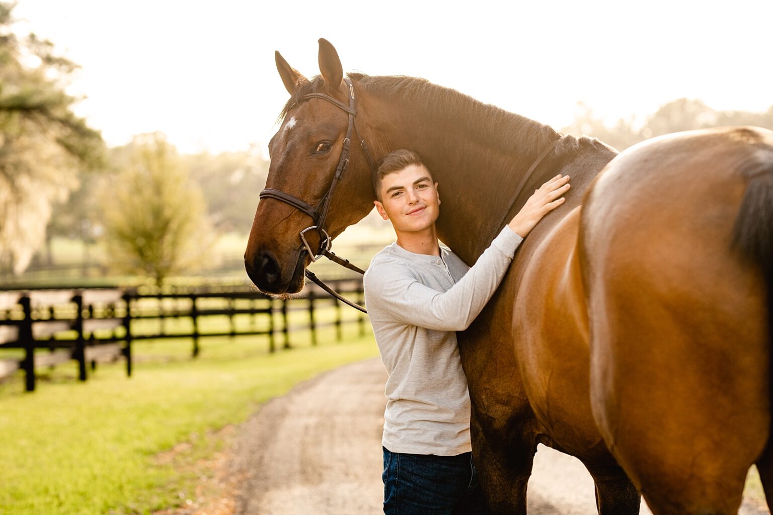 Young rider featured in Sidelines Magazine, Jordan Melfi, takes photos with his jumper gelding in Ocala, FL. Male horse and rider session. Horse and rider posing for men.