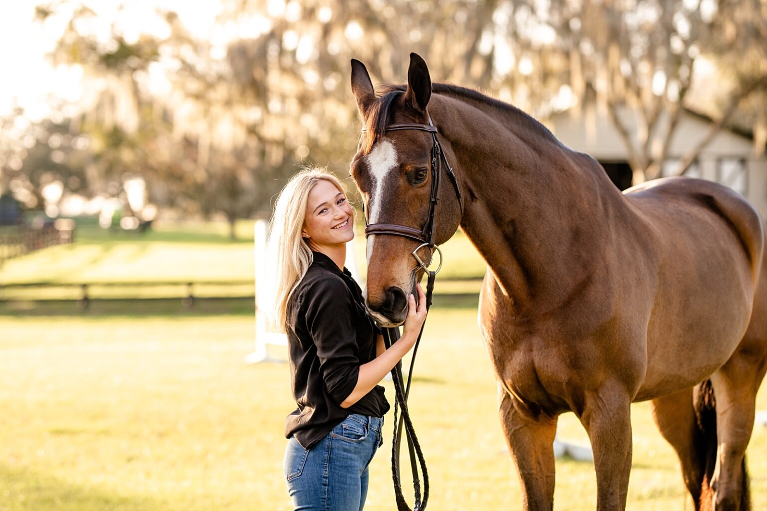 Horse and rider photoshoot in Ocala at Golden Oaks Farm LLC. Hunter/jumper rider attending University of Georgia equestrian team. Senior photos with college attire. Posing for horse and rider.