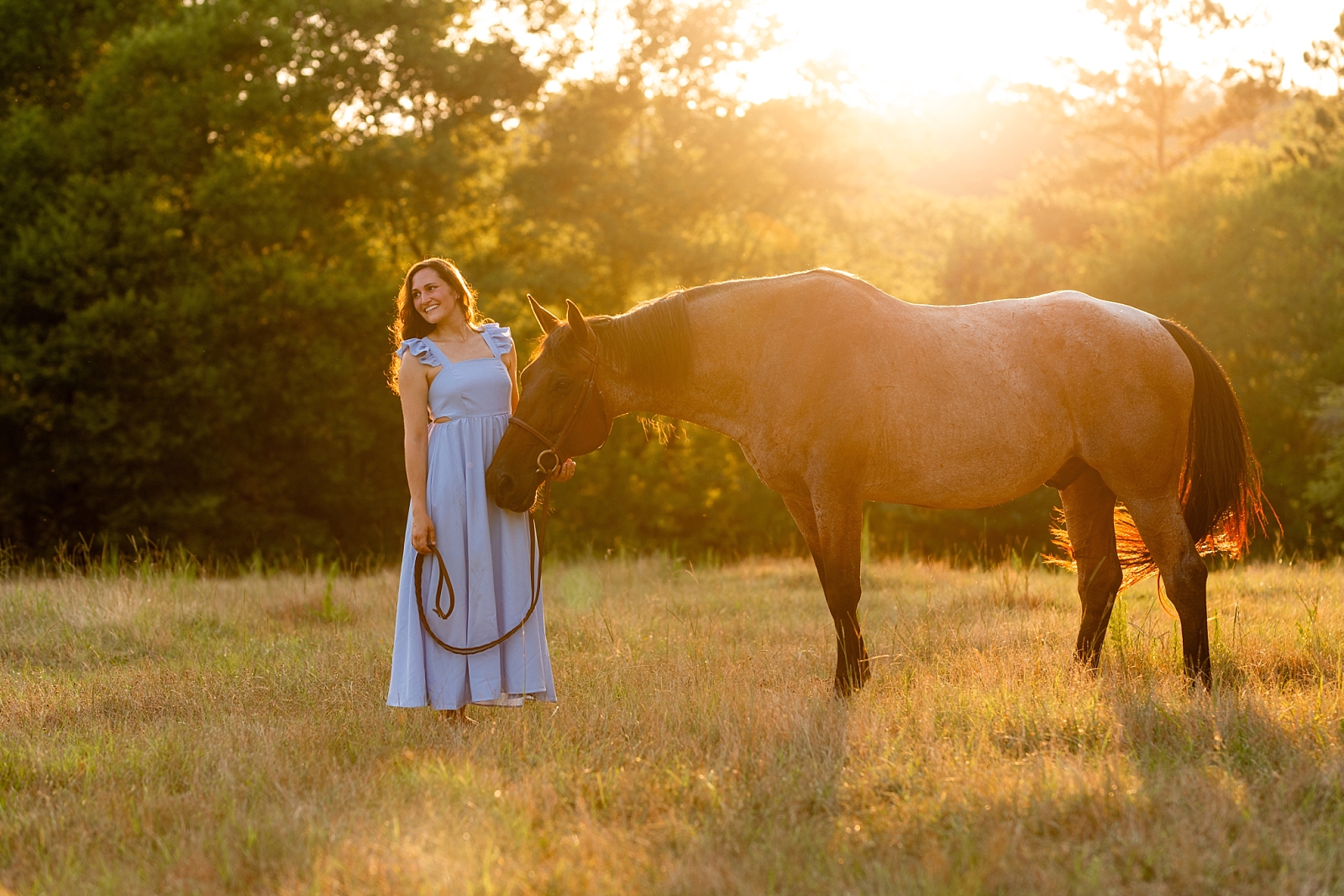 Alabama horse portrait photographer takes photos at sunset of woman with her heart horse. Quarter Horse Gelding.