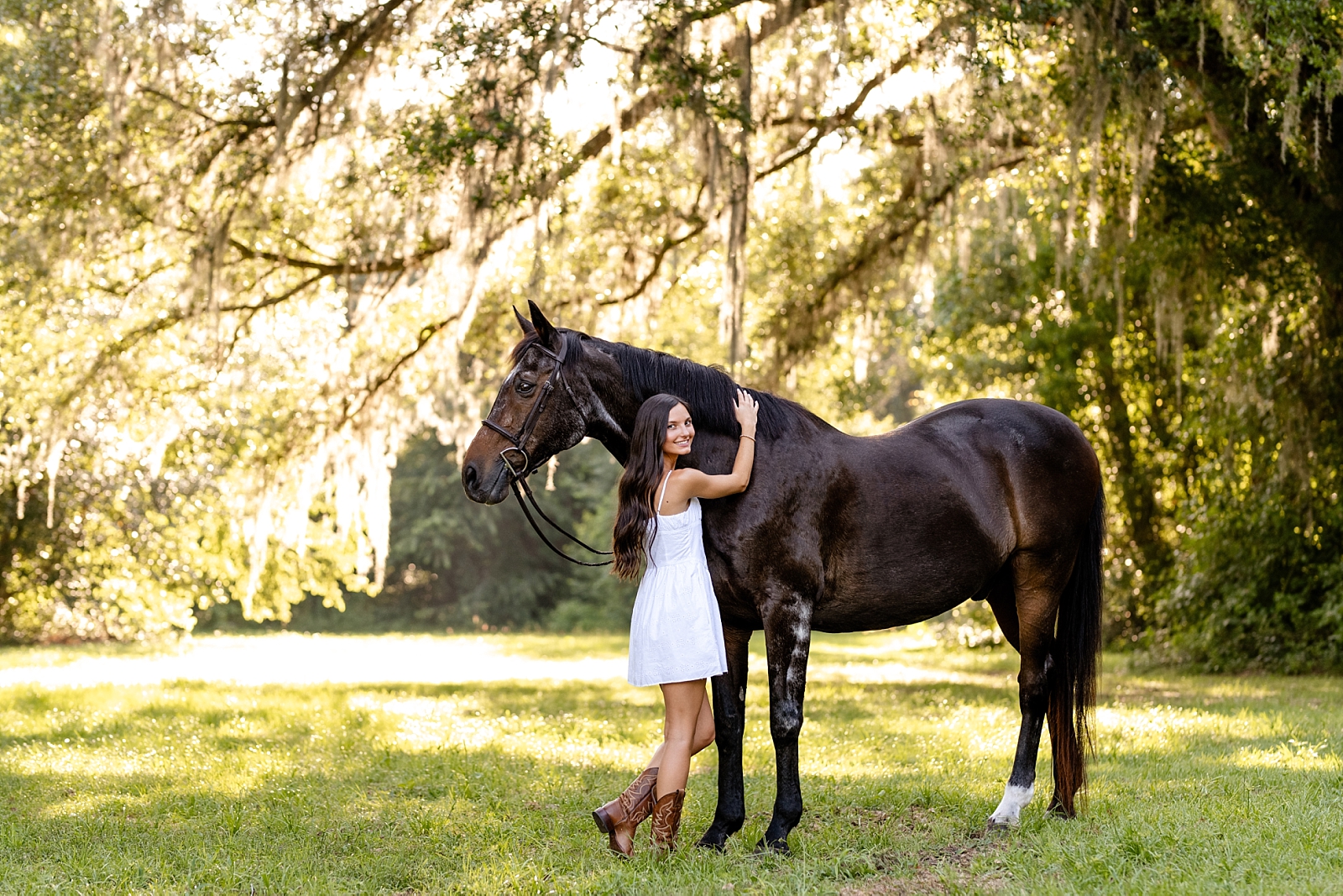 Photos of girl and her horse at Cavallo Farms in Tallahassee, FL. Beautiful oak trees. Posing ideas for girl in white dress with her horse.