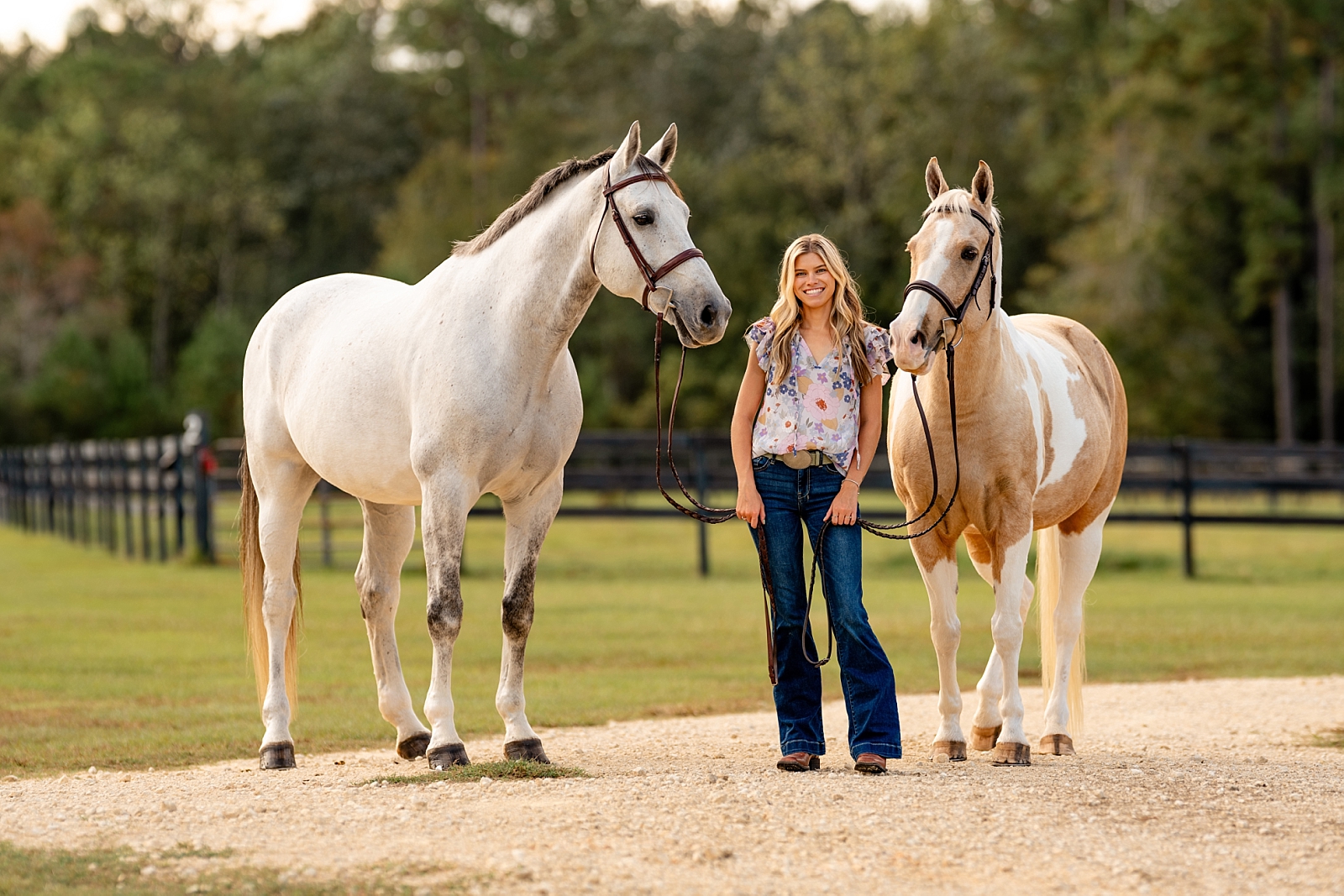 Equestrian portrait of Courtney with her grey warmblood and palomino paint pony during a sunset session in Pensacola, Florida.