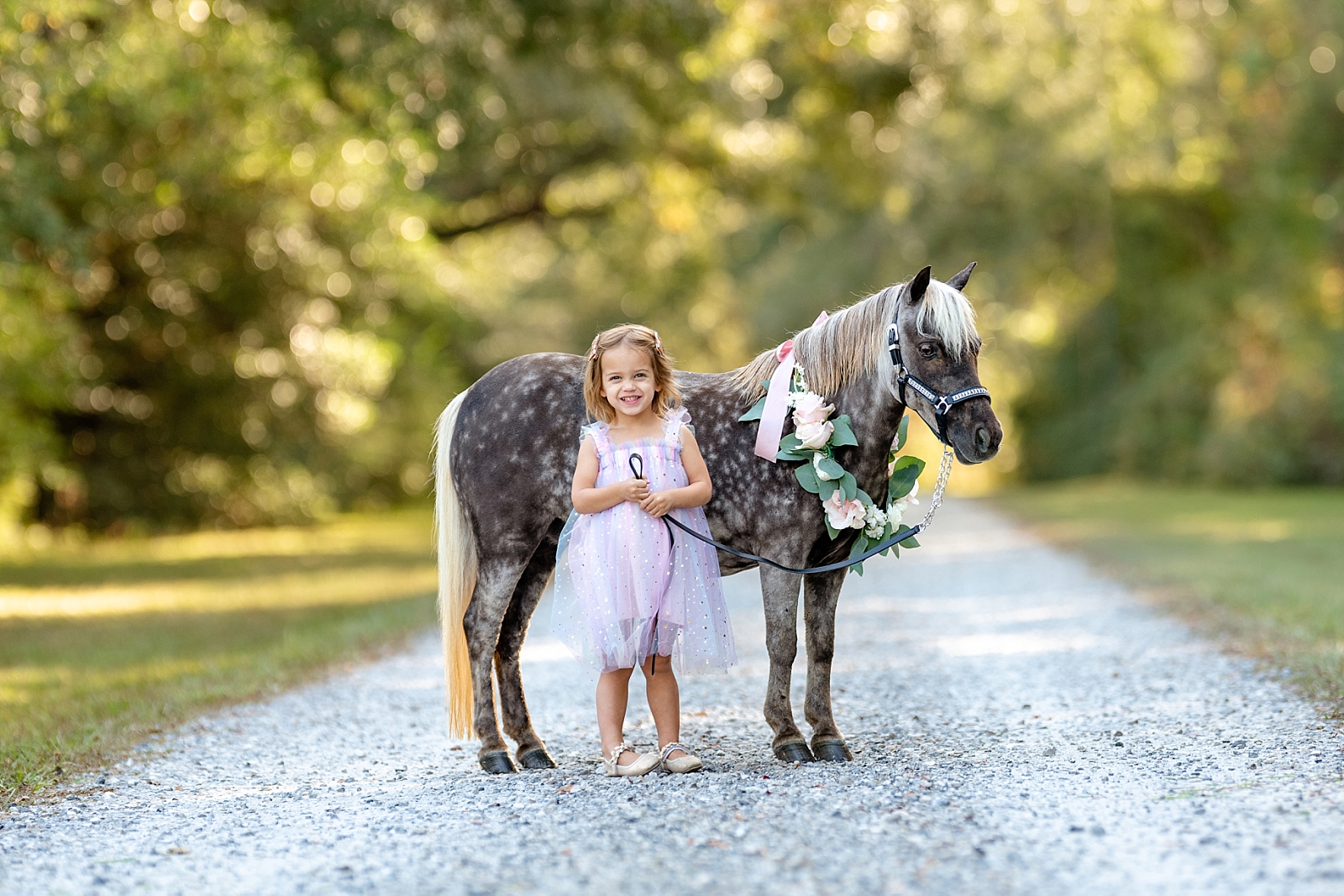 Young girl riding her pony Minnie during a children’s equine photo session in Fairhope, AL.