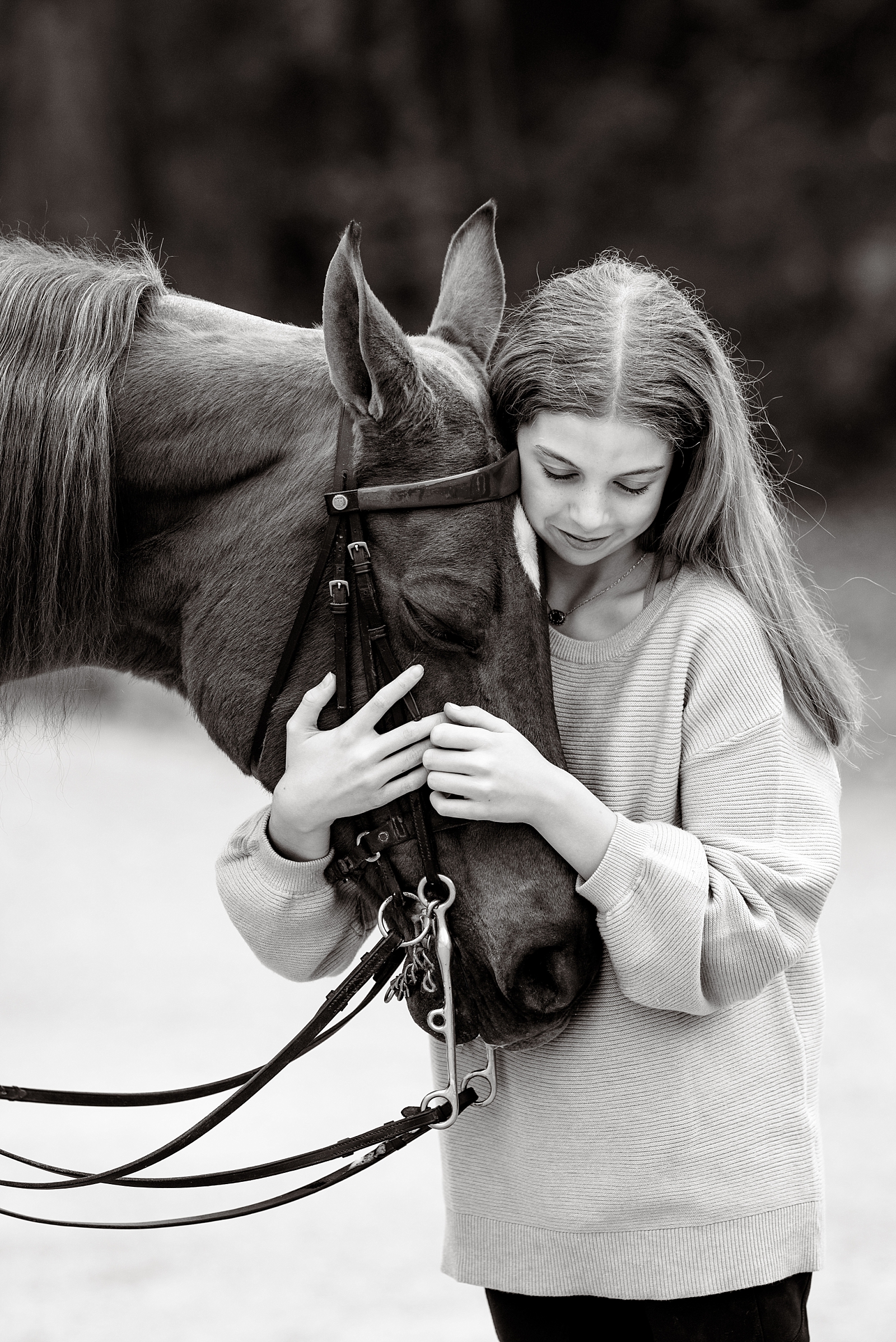 Sweet moment of Madelyn hugging her first horse, Clarice, during a portrait session in Alabama.