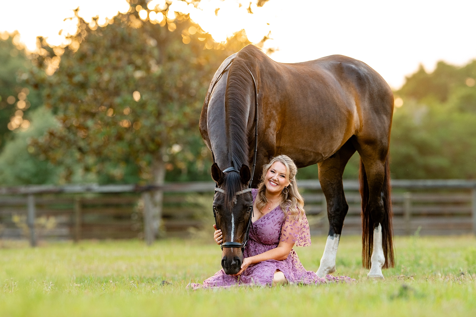 Photographer Caroline poses with her dressage horse, Sento, and her camera during a branding photo session in Ocala, FL.