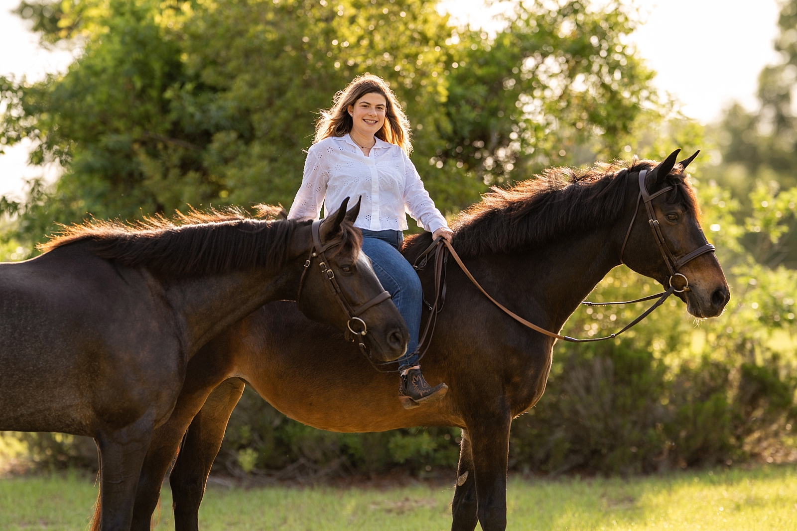 Katie poses with her horses, Pauly and Spencer, at her home barn during a horse photography session in Gainesville, Florida.