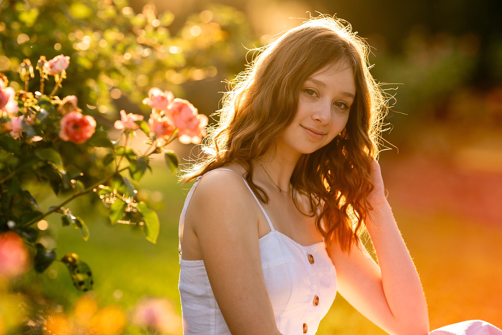 High school senior Margo poses at the rose garden in Thomasville, Georgia during her senior photo session.