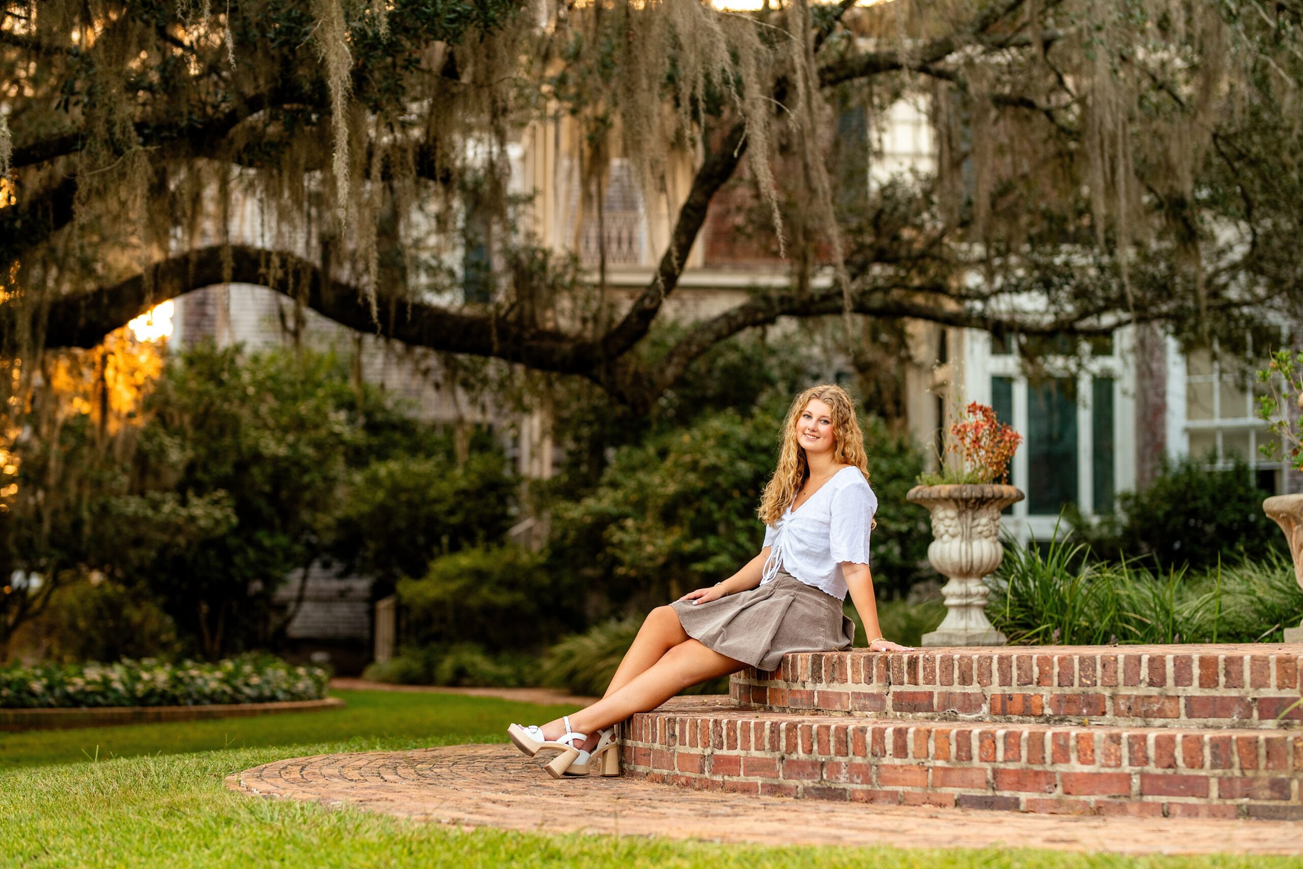 Senior girl posing at Pebble Hill Plantation in Thomasville, Georgia during a golden hour senior portrait session.