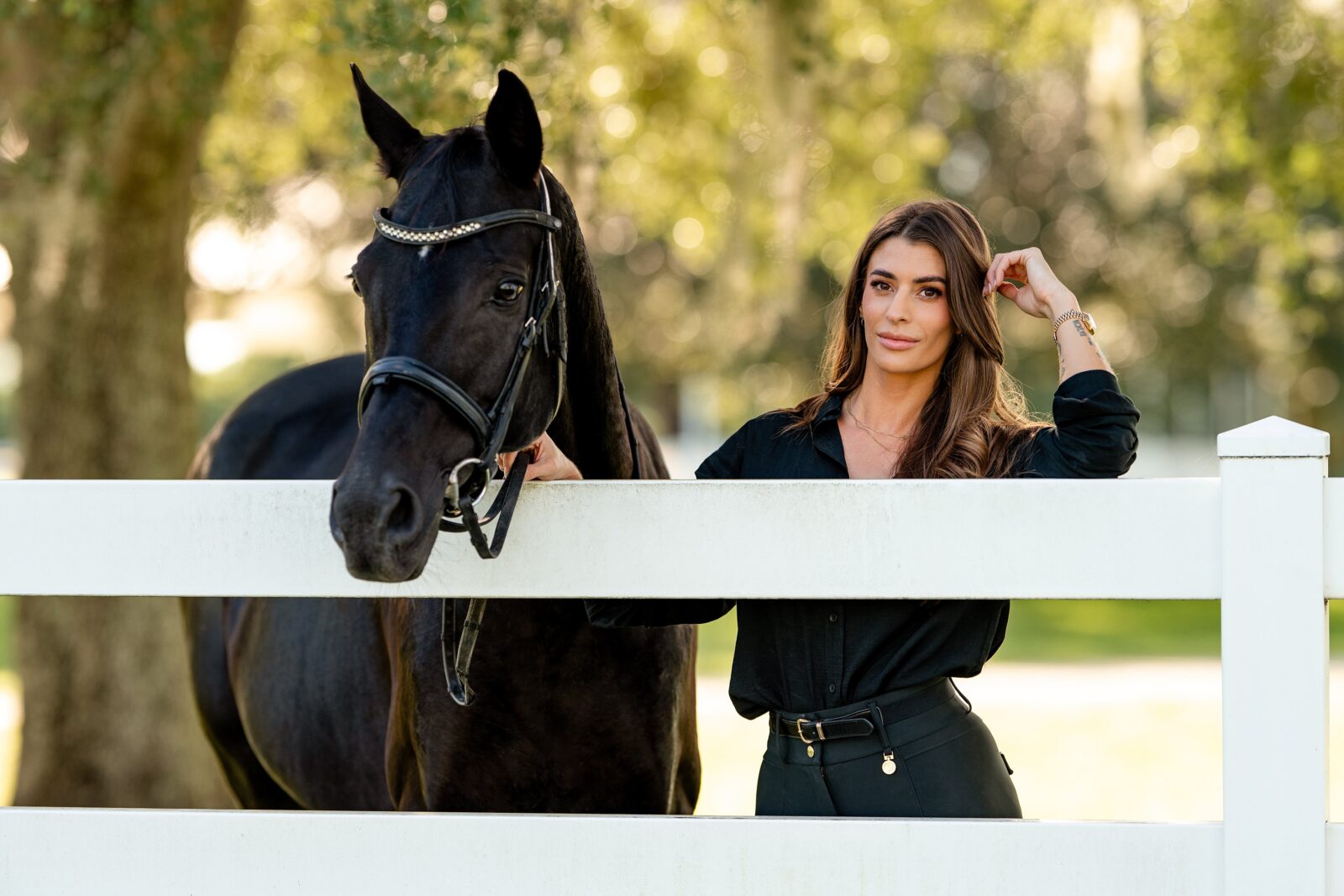Rachel standing with Shana, a black Arabian mare, during a horse and rider photography session near Wellington, Florida.